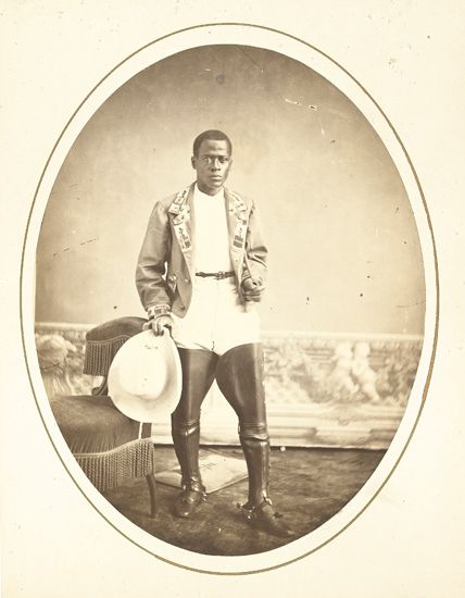 (SPORTS--RODEO.) Oval photograph of an unidentified African American rodeo cowboy.